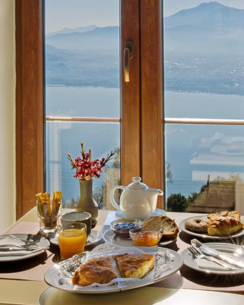 Traditional Greek breakfast with a lake view at Arktos Hotel