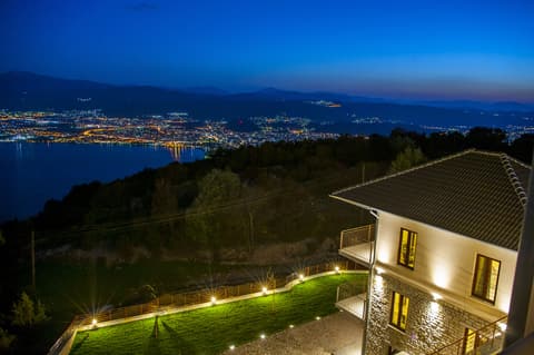 Night view of the Arktos hotel above Lake Pamvotis and the lights of Ioannina
